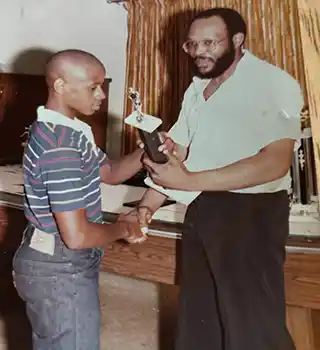 charles gardner giving an award to glenn singleton